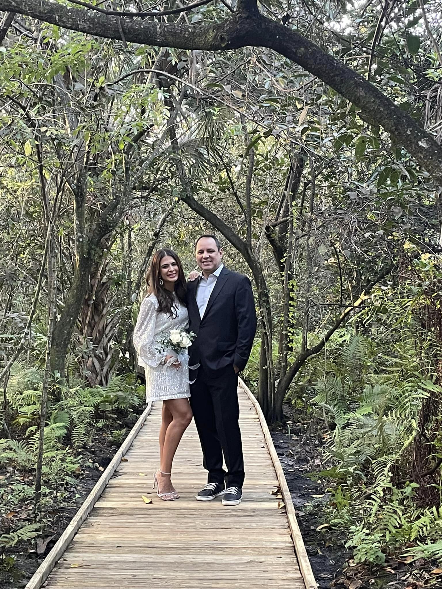 bride and groom posing on boardwalk