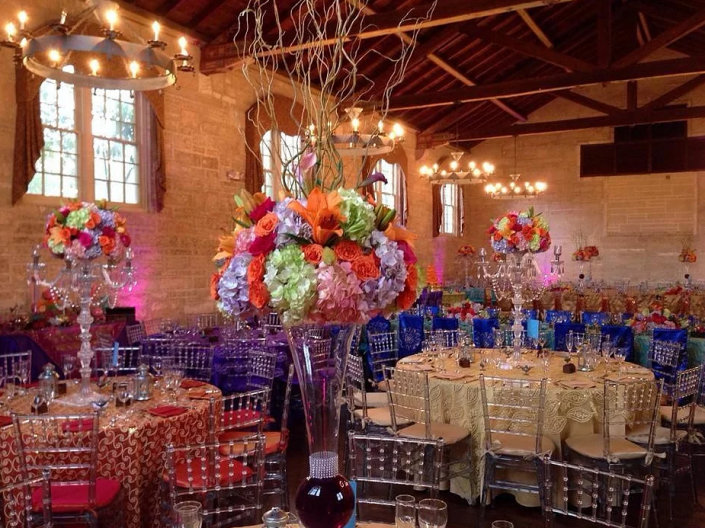 wedding reception with colorful linens and floral centerpieces