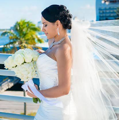 beautiful bride holding a bouquet of white roses