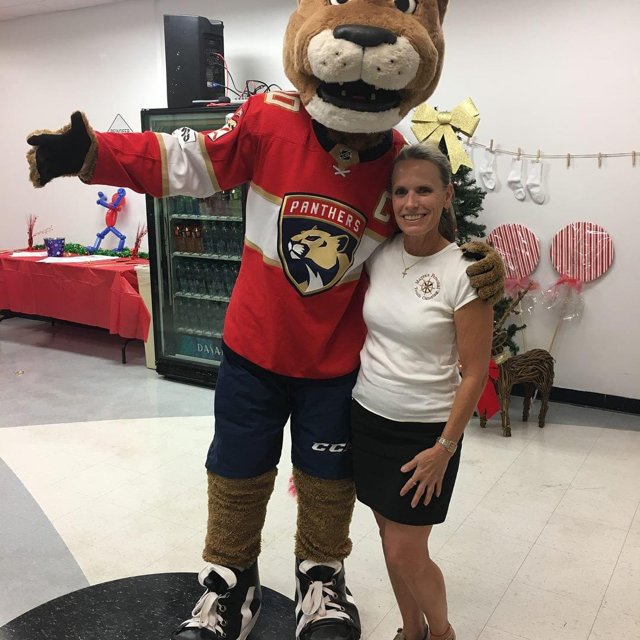 Panthers mascot posing with woman