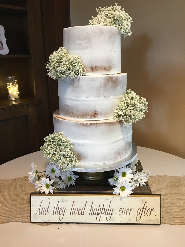 rough iced wedding cake with babys breath